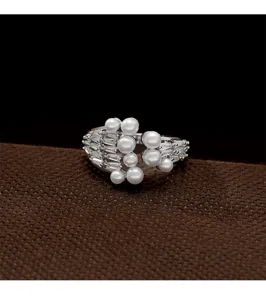 Detail shot of an elegant adjustable pearl ring featuring sparkling baguette zircons