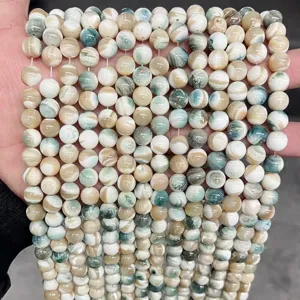 Macro detail of natural freshwater shell beads with blue and cream marbled texture