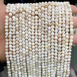 Close-up of natural white mother-of-pearl shell beads for DIY jewelry making