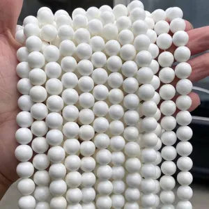 Close-up macro view of high-quality white natural freshwater shell beads for DIY jewelry
