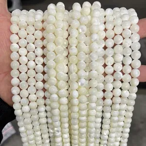 Close-up of natural white mother of pearl shell beads showing iridescent luster and texture