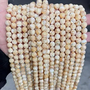 Close-up of natural cream freshwater shell beads with pearlescent texture for DIY jewelry