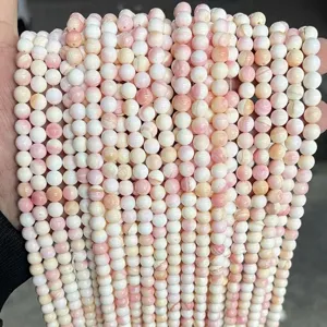 Detailed view of natural pink and white freshwater shell beads for DIY jewelry making