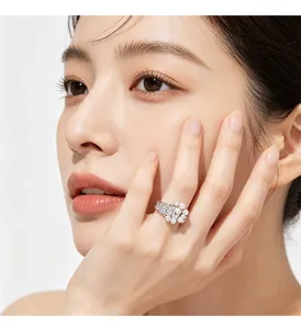 Close-up of an elegant pearl and cubic zirconia ring in silver finish on model's hand.