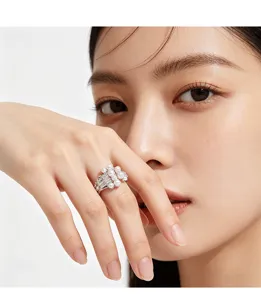 Detailed view of an elegant pearl ring with sparkling zircon stones worn by a female model