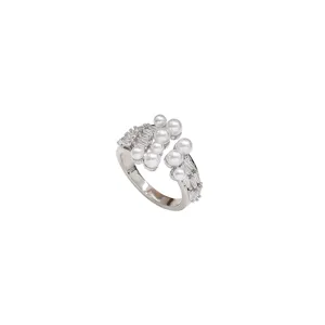 Elegant silver open ring featuring pearls and baguette-cut cubic zirconia accents