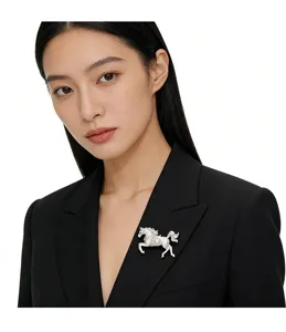 Elegant brushed silver horse brooch with a center pearl pinned on a black blazer lapel