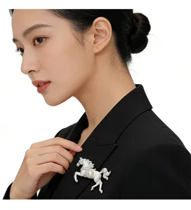 Detailed view of an elegant silver horse brooch pinned on a black suit blazer.