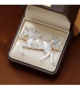 Elegant silver horse brooch with central pearl detail presented in a premium gift box