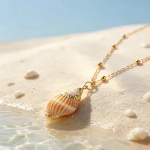 Exquisite seashell pendant necklace detail shot, golden tone ocean beach style jewelry.