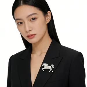 Elegant silver-finished horse brooch with pearl accent pinned on a black blazer