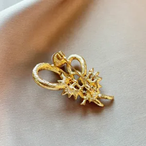 Gold pearl brooch detail view showcasing the delicate metal back pin and craftsmanship.