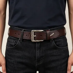 Close-up detail of the vintage brown leather belt featuring unique stitching and retro metal buckle.