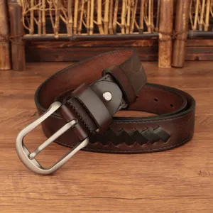 Close-up detail of genuine leather vintage brown braided belt with classic metal pin buckle.