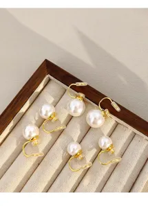 Detailed view of gold-tone clip-on pearl earrings in three different sizes.