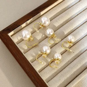 Elegant vintage white pearl clip-on earrings for non-pierced ears displayed in tray