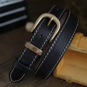 Dettaglio cintura in pelle bovina stile vintage con fibbia in ottone e cuciture fini.