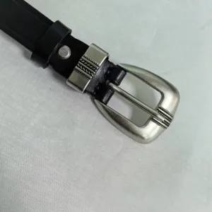 Detail shot of a classic black leather belt with a vintage silver tone zinc alloy pin buckle.
