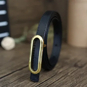 Women's slim black genuine leather belt with elegant gold oval buckle for dresses and jeans.