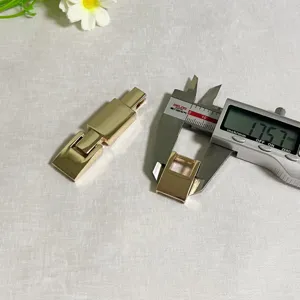 Detailed view of gold metal belt buckle accessories with a digital caliper measuring size.