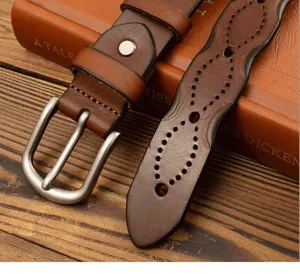 Detailed view of a vintage genuine cowhide women leather belt with retro pin buckle and cutout design.
