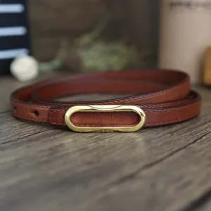 Slim brown leather belt for women with elegant golden oval buckle, casual stylish waist accessory.