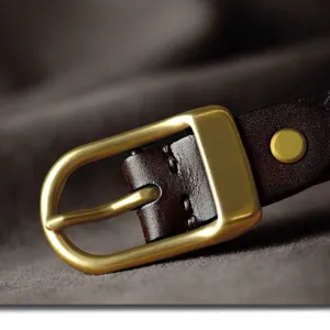 Gold metal pin buckle with leather strap accessory for bags shoes and garments decor