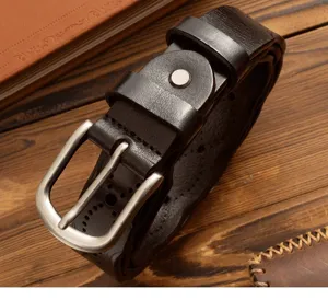 Detailed close-up of a vintage dark brown leather women's belt with pin buckle and punched holes.