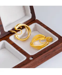 Close-up detail of vintage matte gold clip-on earrings inside a premium wooden box