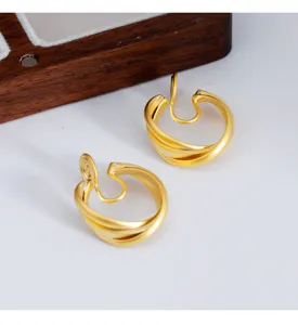 Close-up view of minimalist matte gold clip-on earrings with mosquito coil back design
