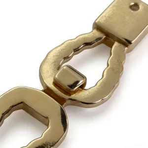 Gold alloy twist buckle metal accessory for women apparel and belt, exquisite design detail.