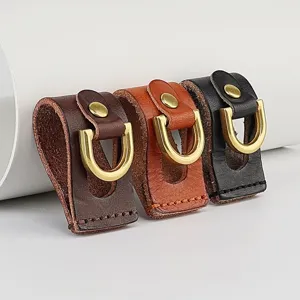 Detailed closeup of handmade top-layer cowhide leather belt loop keychain with brass D-ring clasp.