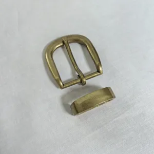 Close-up detail of antique bronze zinc alloy belt buckle and loop accessory for bags and leathercrafts.