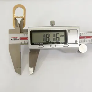 Minimalist metal oval belt slider buckle accessory detail shot showing precise size measurement.