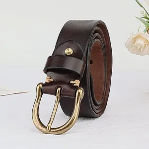 Closeup detail of retro brown cowhide leather belt with vintage brass horseshoe buckle.
