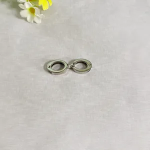 Dettaglio fibbia doppia rotonda in metallo lega di zinco, ideale per cintura e accessori.
