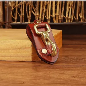 Detailed view of vintage brown leather key holder with durable brass hardware clip.