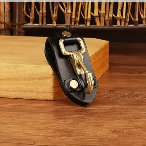 Detailed product view of black leather belt key holder featuring solid brass metal hook and snap.