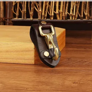 Detailed view of the dark brown leather belt key holder with solid brass hardware clip.