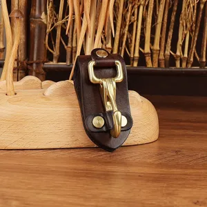 Close-up detail of the durable dark brown leather belt key clip with solid brass hook hardware.
