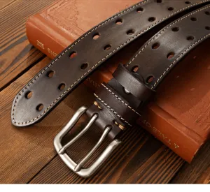 Detail shot of men's dark brown leather belt with double grommets and silver buckle.