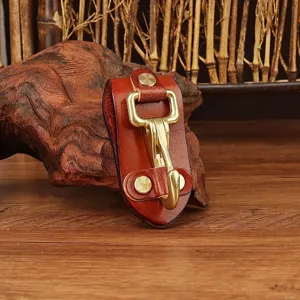 Detail shot of brown leather belt key holder with durable brass hardware clip for daily use.