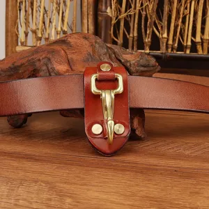 Leather belt key holder with brass hook, durable waist clip accessory for daily use and outdoor tasks.