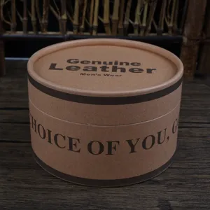 Close-up detail view of a cylindrical brown cardboard box for belts with printed English text