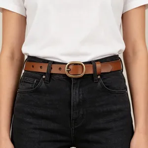 Detailed close-up view of brown leather belt featuring a vintage brass oval buckle.