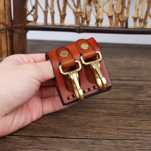 Leather key holder detail showing durable brass hooks and premium craftsmanship for belt loop.