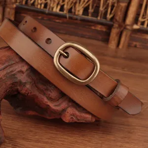 Close-up view of women genuine leather belt featuring retro bronze buckle and cowhide texture.