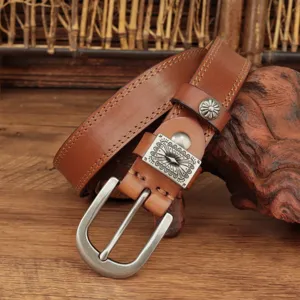 Vintage women's brown leather belt with retro metal buckle and carved decorative accessory.