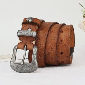 Vintage genuine leather belt for women with embossed pattern and carved metal pin buckle.