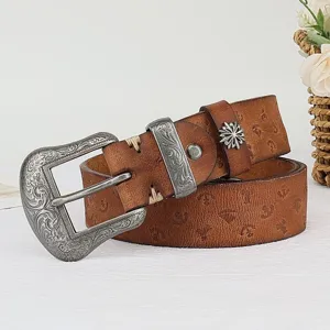 Detailed view of vintage embossed genuine leather belt with ornate carved metal buckle.